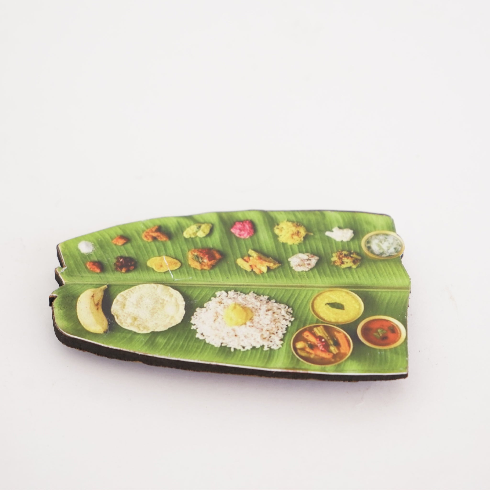 A set of colorful fridge magnets shaped like a traditional Kerala Onam Sadhya meal, displayed on a white background.
