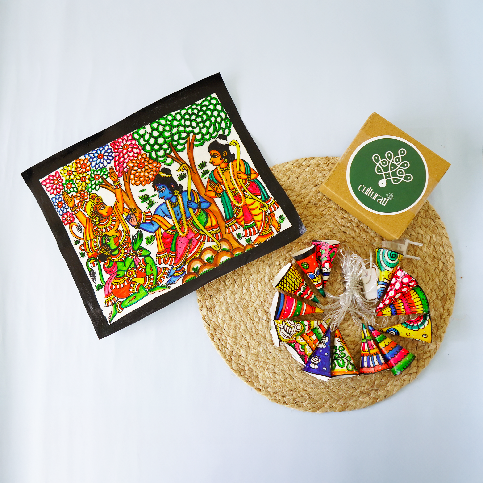 Colorful framed artwork with decorative items on a white background