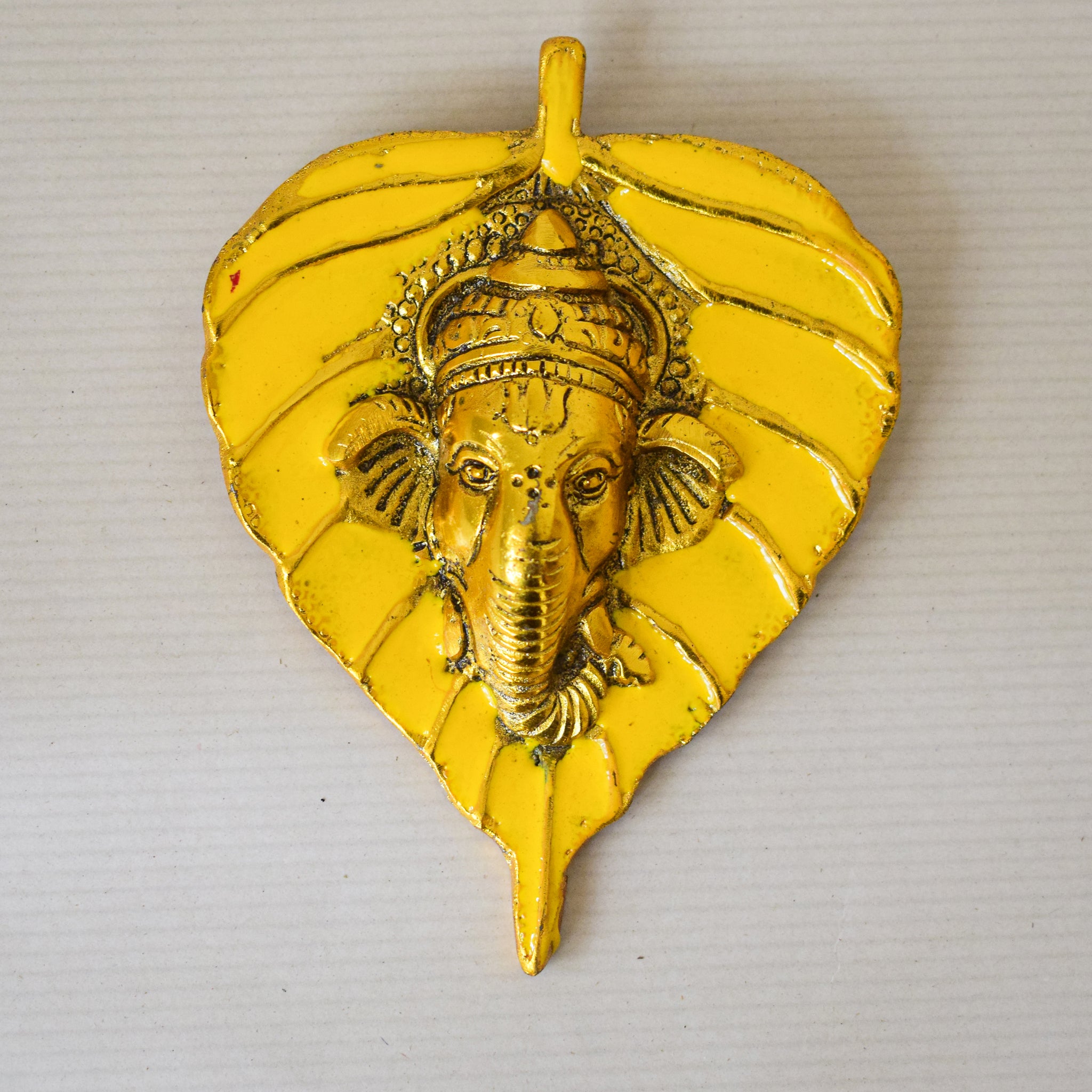 Golden Ganesha Carved on Radiant Peepal