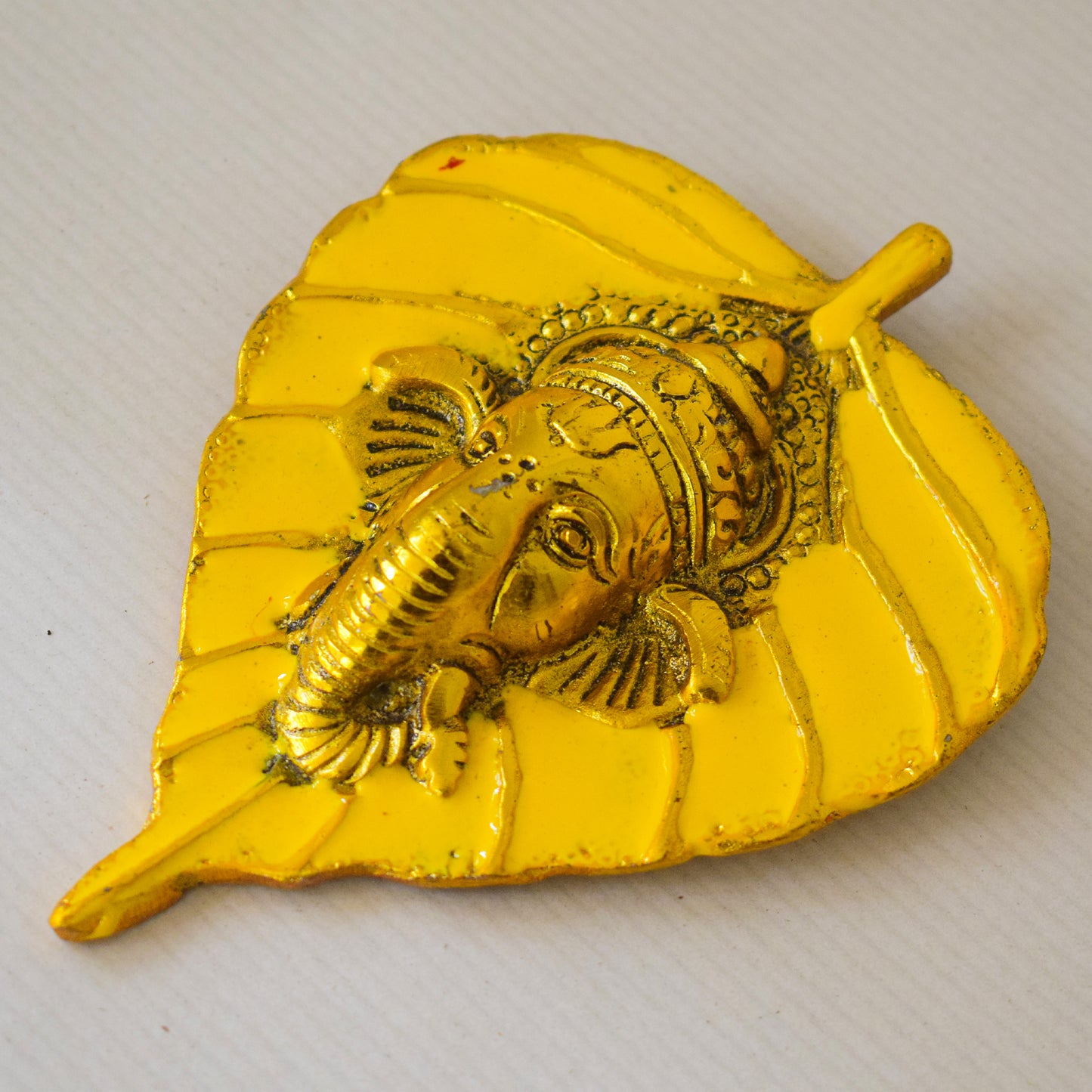 Golden Ganesha Carved on Radiant Peepal