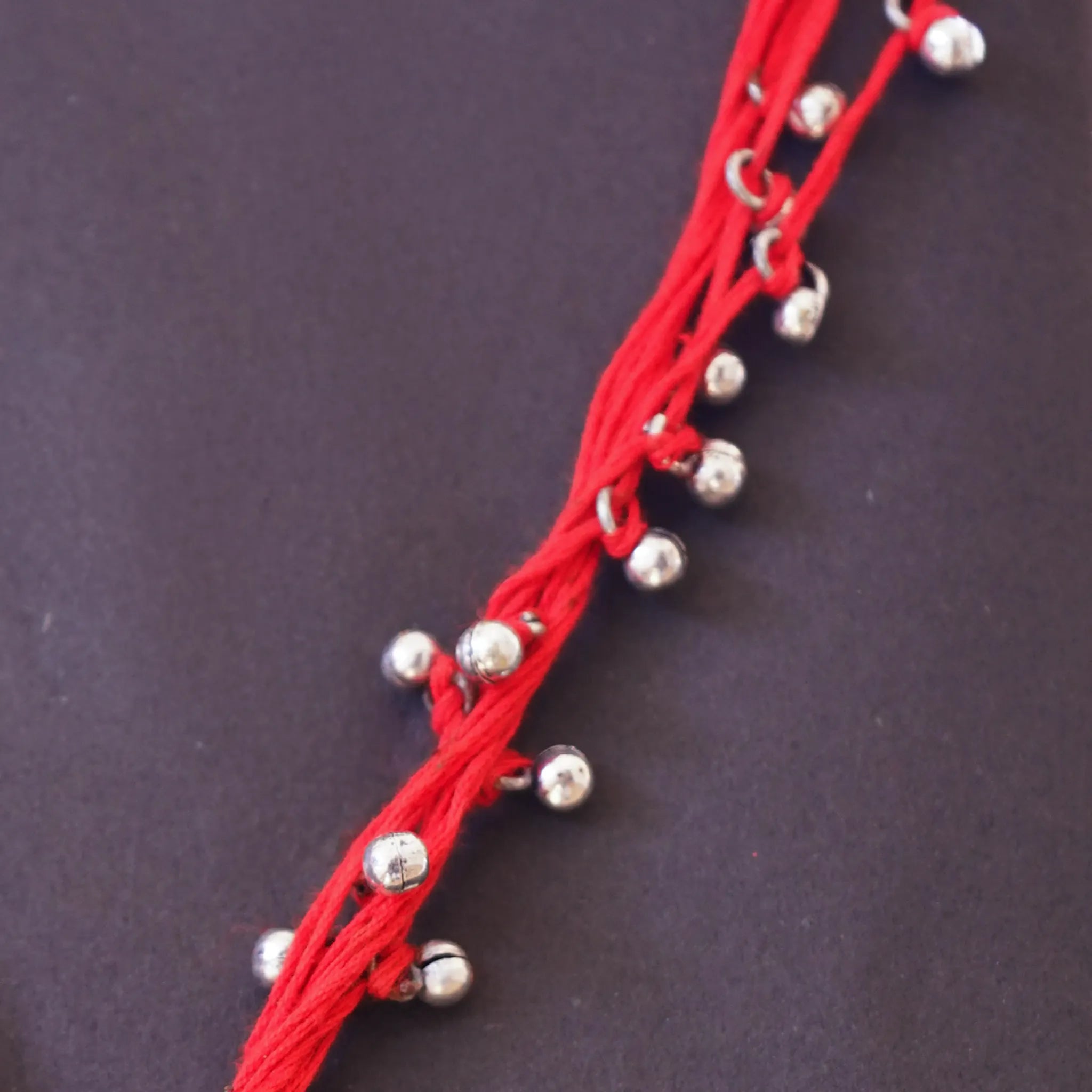 Vibrant Red Thread Neckpiece with Silver Bell Beads and Oval Pendant