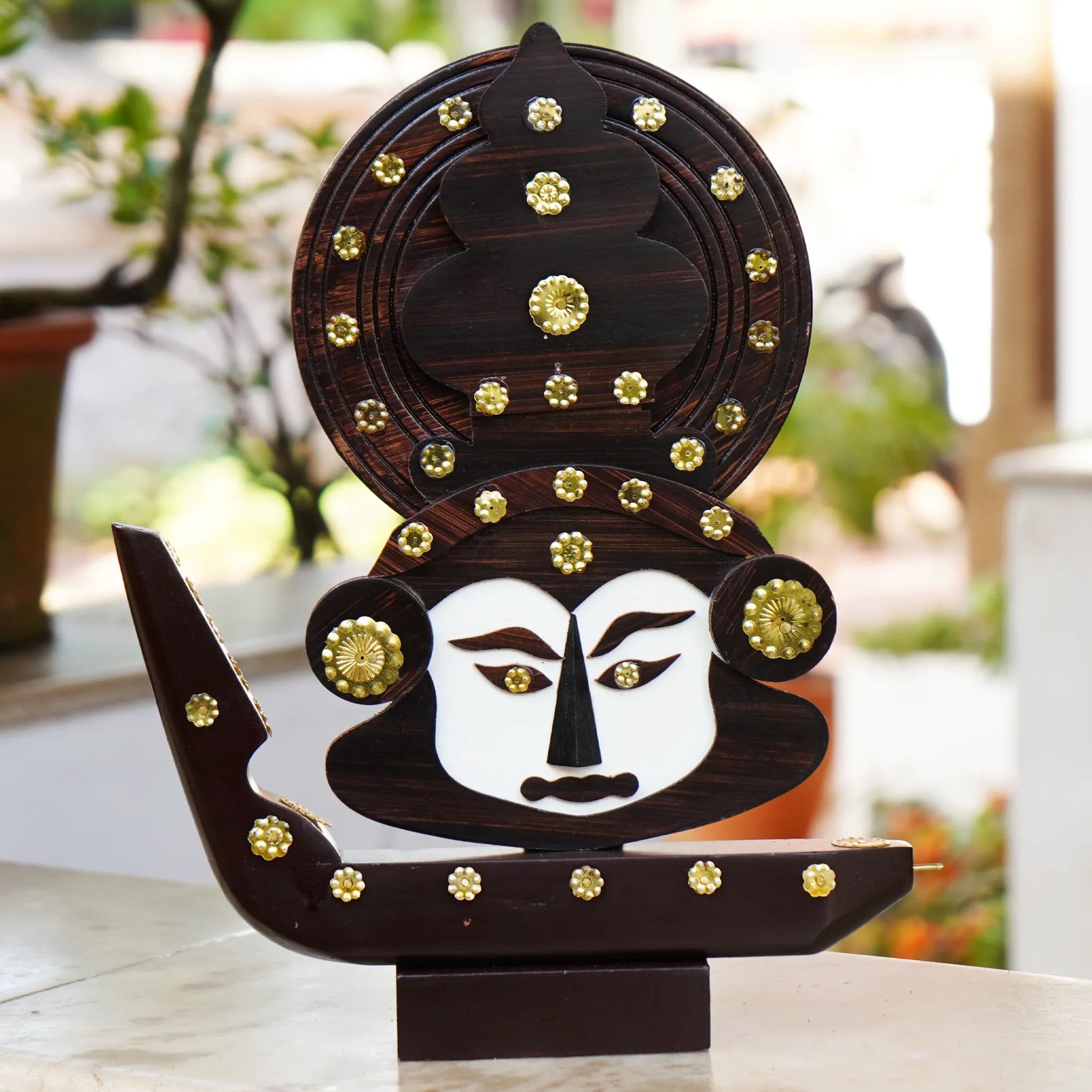 wooden boat with a Kathakali head