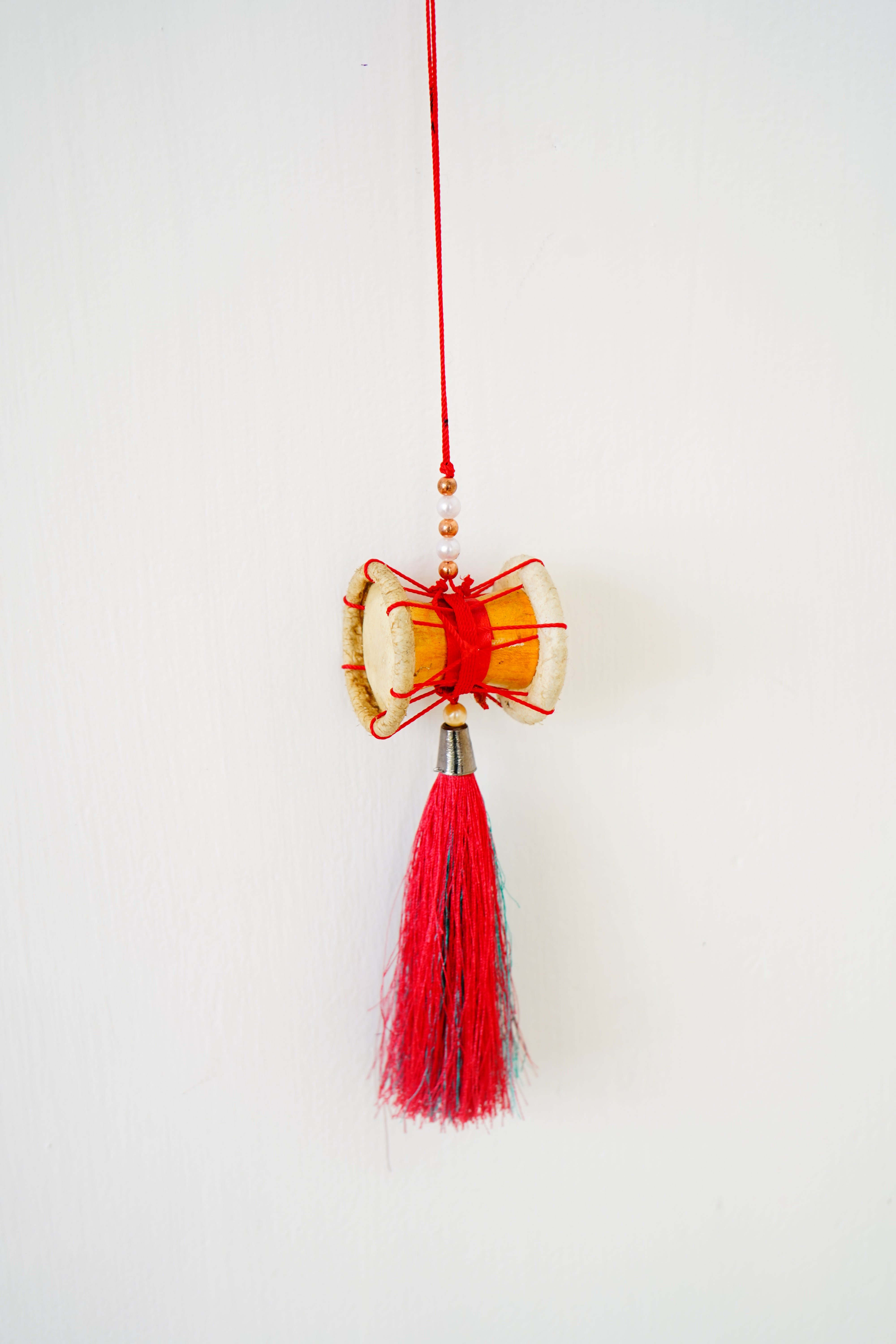 Vibrant Shivan Udukai Decorative Hanging with Red and Blue Tassels