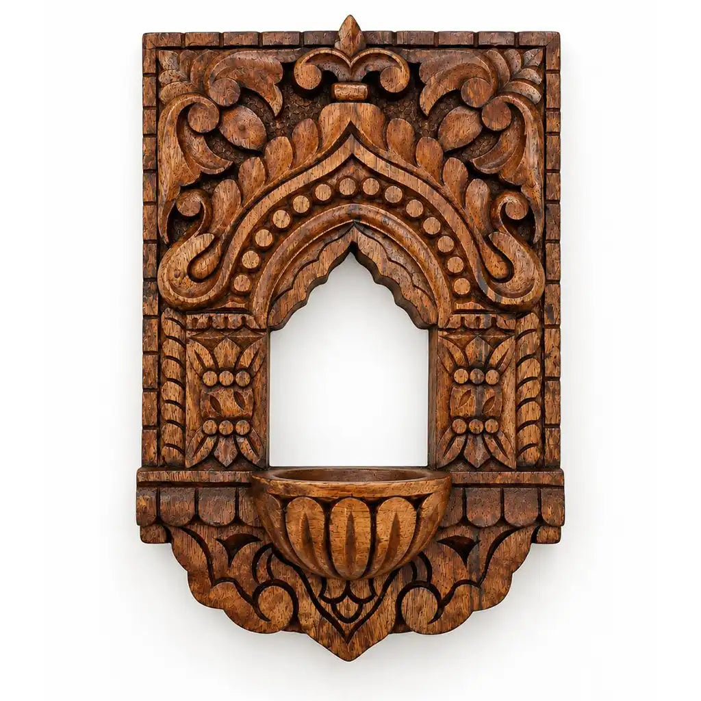 Close-up of floral relief carving on wooden vilakku maadam lamp niche