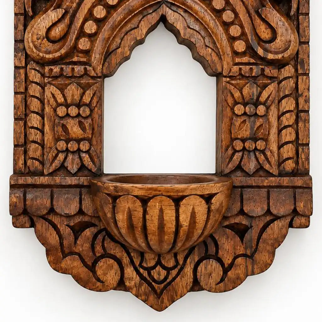 Close-up of floral relief carving on wooden vilakku maadam lamp niche